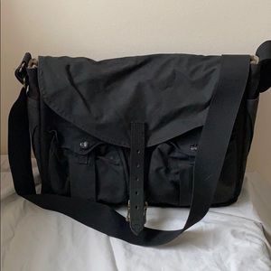 Filson black canvas and orange mesh messenger bag
